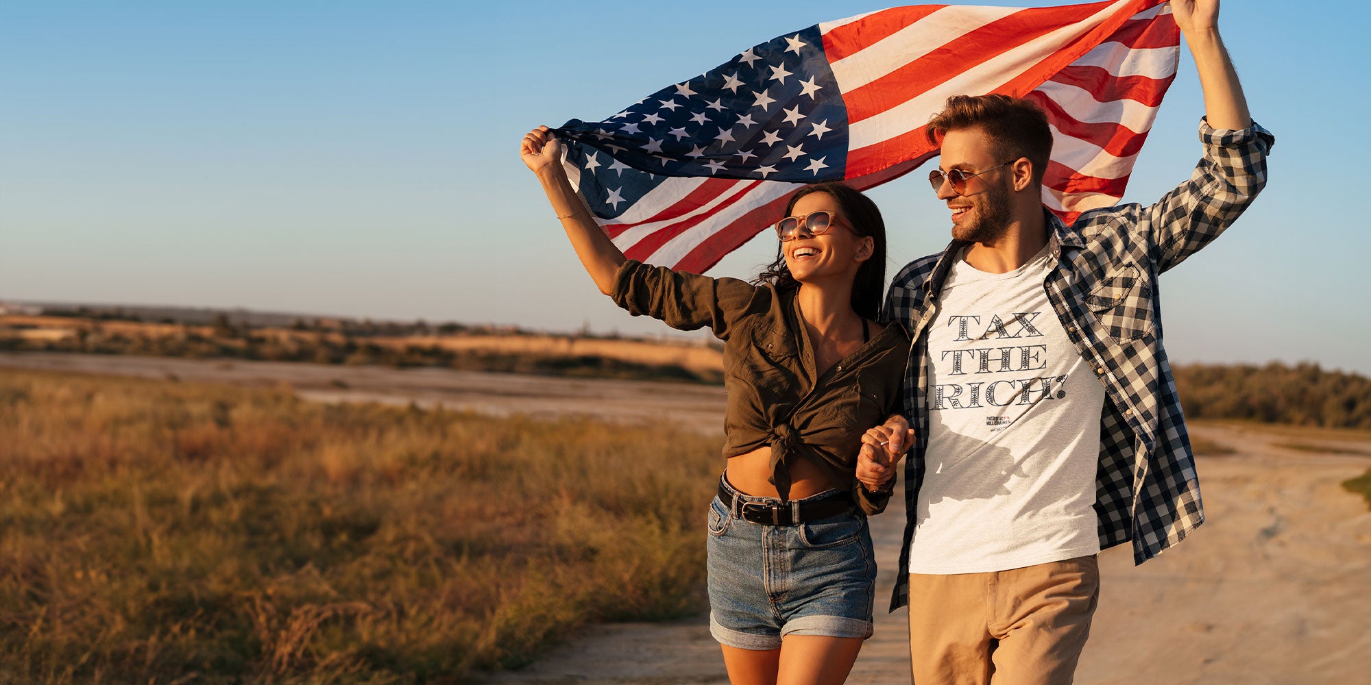 man and woman holding American flag